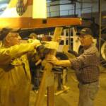 John Campbell and Henry Dechant building a sling to store the rudder, after it gets new fabric.