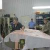 Doug Roy, left, applies the Polly Brush to the almost finished rudder, middle - Norbert Luken, right - Floyd Stromstedt