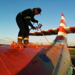 AME Summer Job Student, Rob Simon on top of things, applying orange paint.